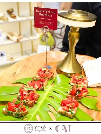 Fresh Basil and Tomato Bruschetta served on a Monstera leaf for a tropical, stylish presentation. This was part of our catering for a grand store launch, showing how we tailor our food to fit the event's theme.