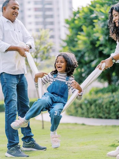 A girl laughing with joy as her parents swing her in a blanket. This is the kind of pure, unadulterated fun I love to capture.
