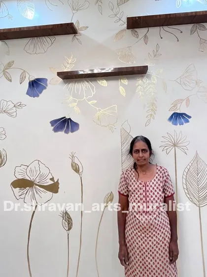 My mom standing proudly in front of the viral gold foil mural she helped create. She is happy and proud of the work she is learning and doing, and I'm blessed to have her with me.