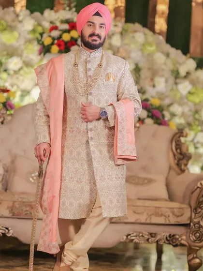 A classic portrait of the groom in his elegant sherwani, looking poised and ready for the ceremony.