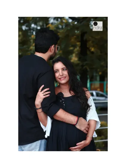 A tender moment between the couple during their outdoor maternity session, with the father-to-be gently holding his partner.