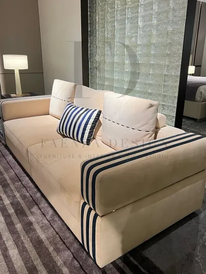 This sofa features a unique design with striped detailing on the arms, adding a graphic, modern touch to its classic form. It's a perfect example of how I incorporate small, custom details to make a piece stand out.