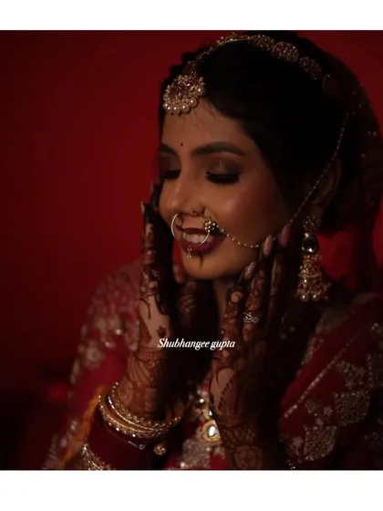 A happy bride showing off her gorgeous, dark mehndi stain on her wedding day. This is the beautiful result after the henna paste has been removed and the color has matured.