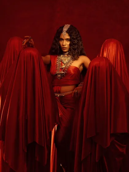 A powerful group composition where the central figure stands among the shrouded forms. This image tells a story of emergence and power, with the jewelry as her armor.
