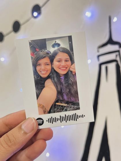 A polaroid-style print with a scannable Spotify code, linking a favorite photo with a special song.