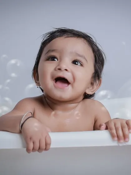 Looking up at the floating bubbles with wonder. These photos capture the simple, magical moments of childhood discovery and joy.