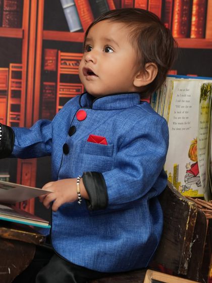 A close-up from the 'School Time' themed shoot. This little scholar looks so curious as he holds a book, with a wonderful expression of discovery on his face.
