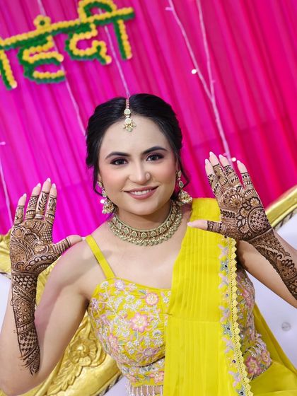 A joyful shot of the bride, ready for her mehndi ceremony.