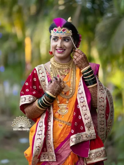 A stunning portrait of a bride in her traditional attire. The rich color of her mehndi complements the vibrant colors of her saree and jewelry.
