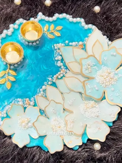 A close-up of the stunning blue flower platter, showing the detail on the handmade resin flowers and the pearl accents.