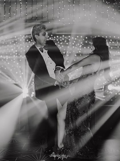 A creative, motion-blur shot of the couple's first dance, capturing the movement and the stunning light display.