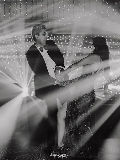 A creative, motion-blur shot of the couple's first dance, capturing the movement and the stunning light display.