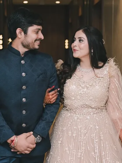 A candid shot of a couple walking and talking in a hallway, capturing a natural moment during their engagement event.