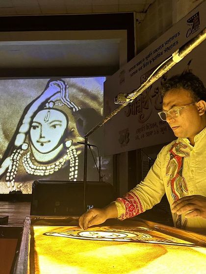A close up of my sand art performance. With my hands, I shape the sand to create intricate and beautiful images that flow from one to the next.
