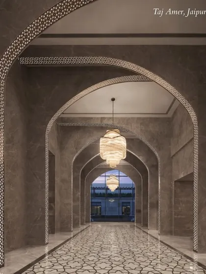 The arched hallways of Taj Amer, Jaipur, showcase modern design with a nod to traditional architecture. The lighting and patterns create beautiful photo opportunities.