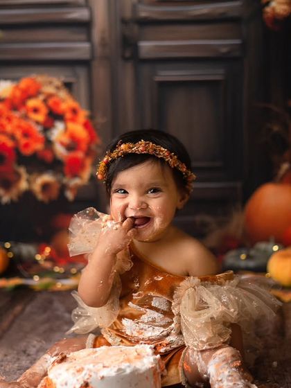 Falling in love with this little darling. Her sweet, frosting-covered smile during her autumn-themed cake smash session is a moment to treasure forever.