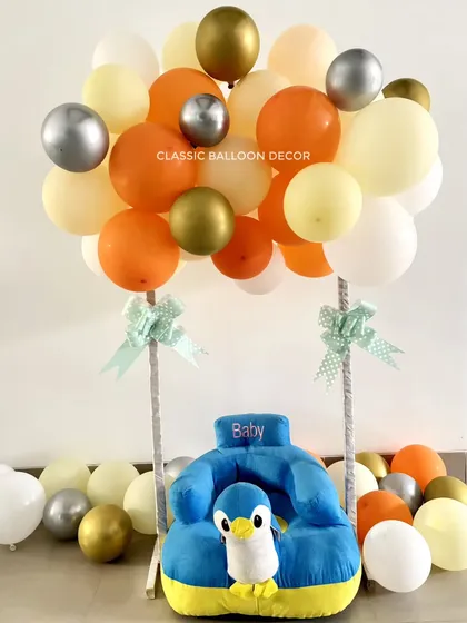 A cute and simple photobooth idea for a baby welcome. We created a hot air balloon effect using a baby seat and a bunch of balloons.