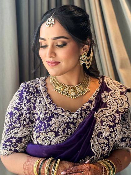 A serene portrait of Ruchita. The soft, shimmering eyeshadow and perfectly blended skin create a look that is both elegant and modern, even in a traditional saree.