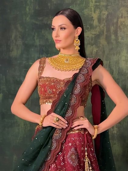 A full-length shot showing the entire look. The makeup, jewelry, and outfit all work together to create a vision of modern royalty.