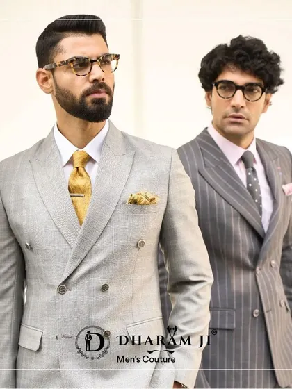 Two examples of my double-breasted suits. On the left, a light grey suit with a gold tie, and on the right, a pinstripe suit. Both are tailored to perfection for a sharp, professional look.