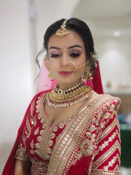 A candid, smiling shot that shows the makeup in natural light. The soft eye makeup and lip color create a very pretty and elegant bridal look.