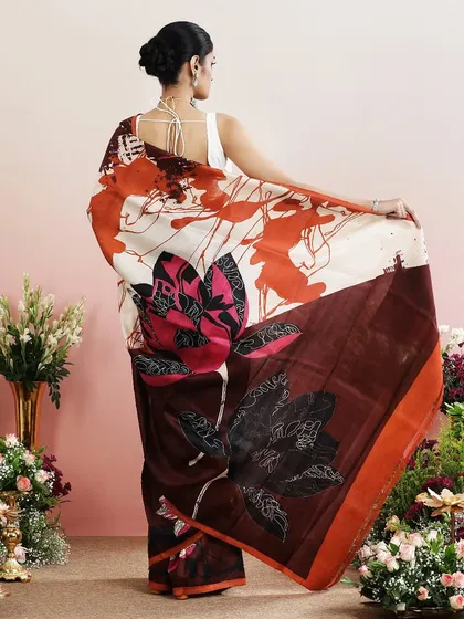 The back view of the brown abstract floral saree, showcasing the dramatic pallu.