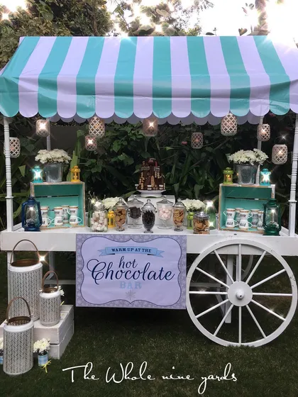 A custom hot chocolate bar I designed for a camp-out birthday. The cart was stocked with marshmallows, chocolate chips, and other toppings for a cozy treat.
