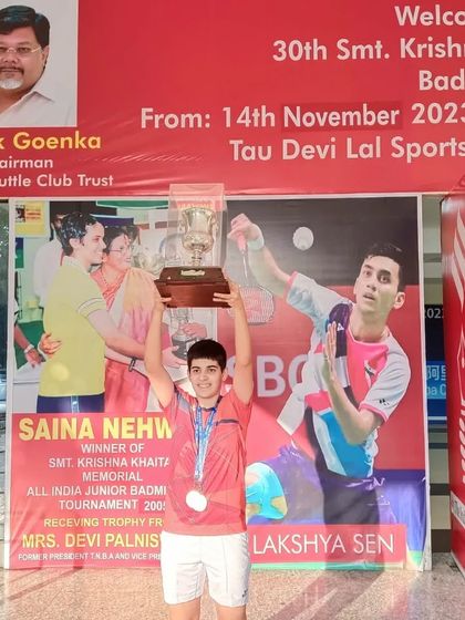 **Double Gold at Krishna Khaitan Memorial.** Anmol Kharb holding the trophies for her double victory in both Girls' Singles and Girls' Doubles U-19 at the prestigious All India Junior Ranking Tournament in Panchkula.