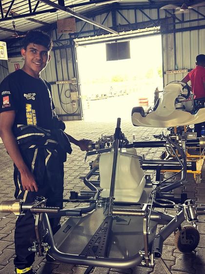 A driver stands proudly with his new Kart Republic chassis.