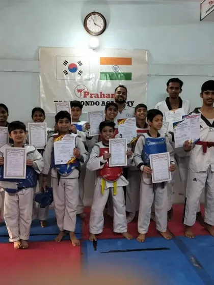 A large group of our students with their certificates after a belt test. This shows the scale of our growing Taekwondo family.