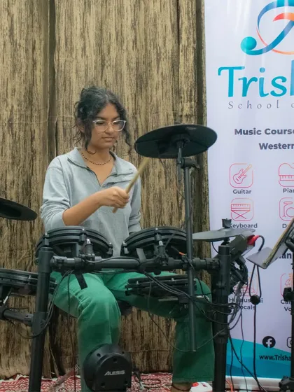A student honing her skills on the electronic drum kit during an open mic session at our HSR branch. We provide training on a wide range of modern and classical instruments.