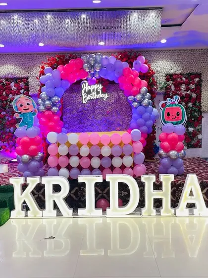 Another angle of the grand Cocomelon birthday setup for Kridha, showing the scale and detail of the stage decoration in the banquet hall.