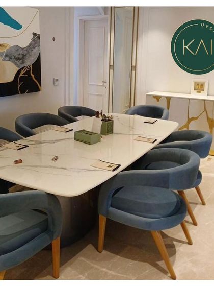 A complete dining room view, featuring a marble-topped table, blue velvet chairs, and a matching sideboard with a unique gold-vein pattern. The entire space is designed to be cohesive, modern, and luxurious.