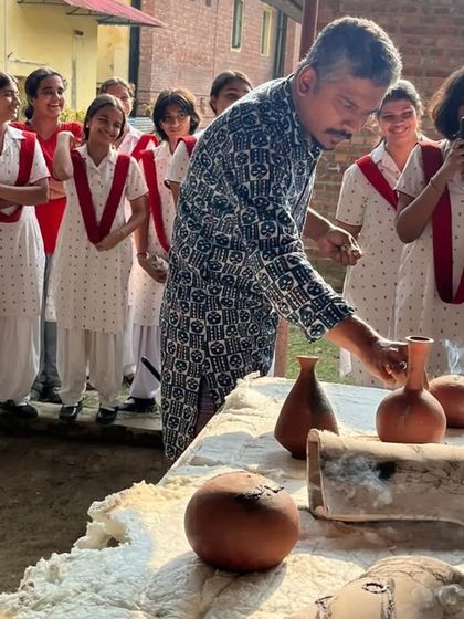 A guest artist demonstrates the Raku process to students. The smoke rising from the finished pieces adds to the drama and excitement of the reveal.