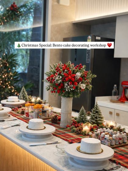The studio all set up for a Christmas special bento cake decorating workshop. Each station is ready with a blank canvas cake, piping bags, colors, and sprinkles, waiting for our guests to arrive and start creating.