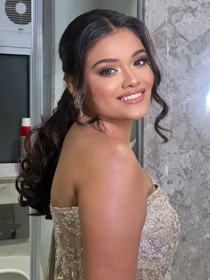 A front view of the half-ponytail. The hair is given volume at the crown and soft waves frame the face, creating a flattering look.