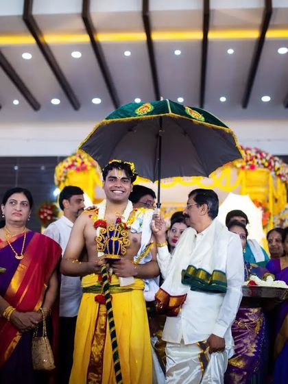 A wide shot of the groom's Kashi Yatra procession, surrounded by his family. We capture the entire scene and the involvement of loved ones.