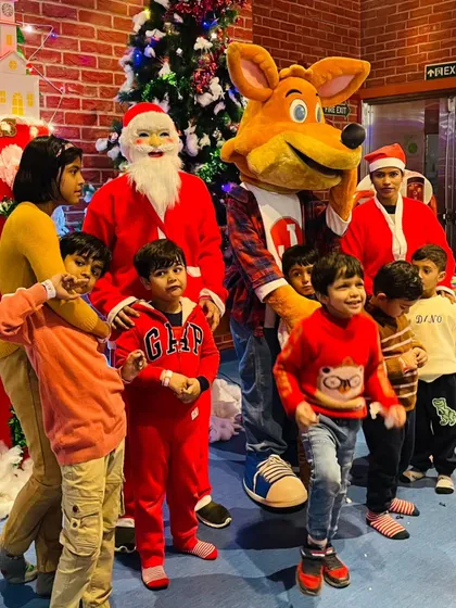 Santa Claus and J the Fox team up to bring holiday cheer to the kids during our Christmas party.