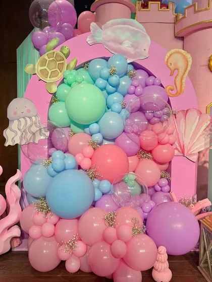 From a pastel soft play area and a cotton candy cart to a buffet with an LED screen backdrop showing aquatic life, every element was designed to immerse guests in Miraya's mermaid world.