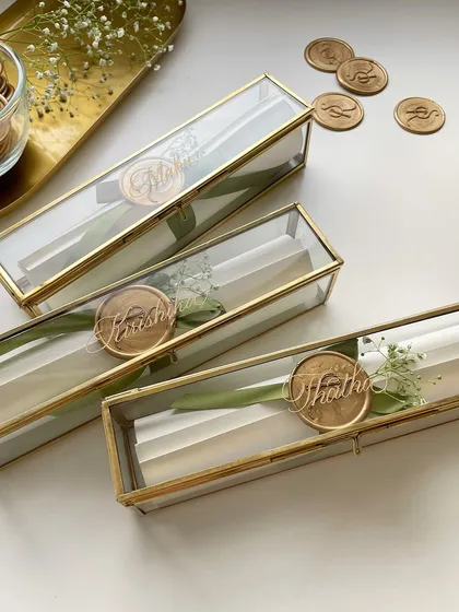 A closer look at the wedding scroll invitations. Each one is personalized with an engraved name on the wax seal, adding another layer of detail.