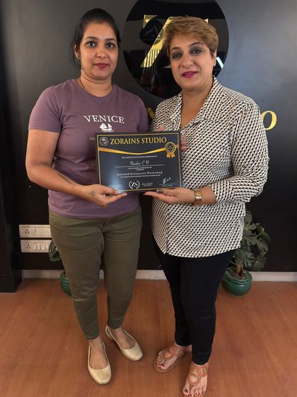 A student proudly receives her certificate after completing the Elleza Lash Extension hands-on workshop. We celebrate every student's success as they embark on their new career path.