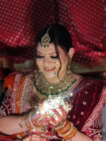 A creative shot with fairy lights, adding a magical touch to her bridal portrait.