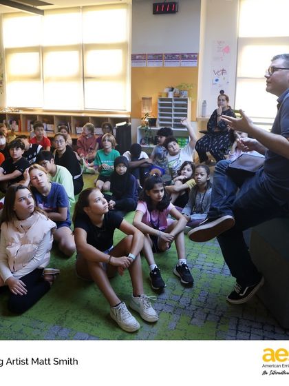 A visiting artist speaks to a captivated audience of elementary students. We believe in inspiring creativity from a young age by introducing students to passionate professionals.