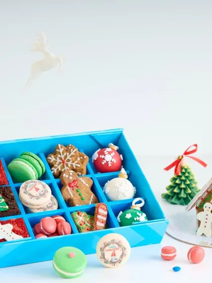 Our Christmas 'Happiness Box' is filled with an assortment of holiday treats, including gingerbread cookies, macarons, and chocolate bombs.