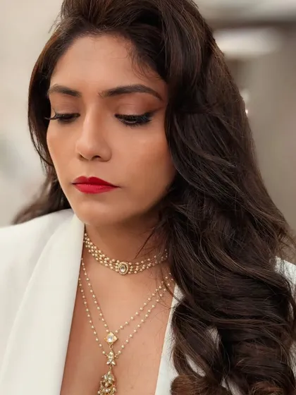 A downward glance showing the flawless application of the winged liner and red lipstick. Every detail is precise to achieve this polished, vintage-inspired look.