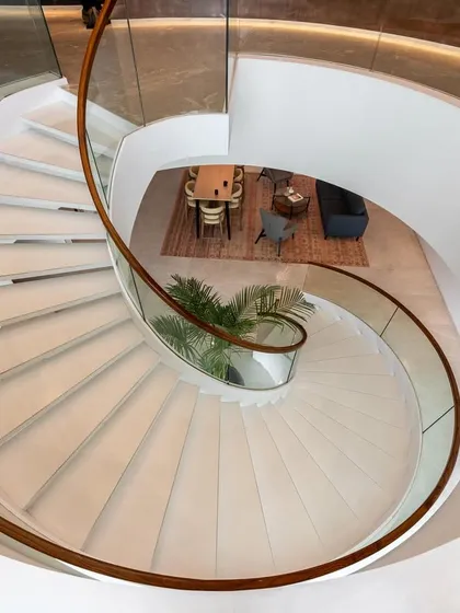 The sculptural spiral staircase at the Asian Paints headquarters serves as a central connecting element, embodying the brand's commitment to design and innovation. It is more than a means of circulation; it is a statement piece that anchors the executive floors.