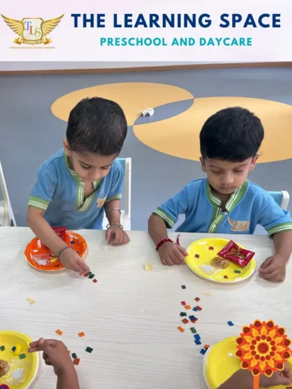 Children concentrating on making their own rakhis. This hands-on activity helps them understand the tradition of Raksha Bandhan while practicing their fine motor skills.
