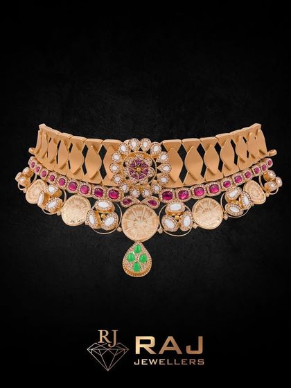 A classic Revaj choker featuring coin-like elements and a central floral medallion. The rich red stones and delicate pearl drops create a timeless piece that exudes traditional charm and elegance.