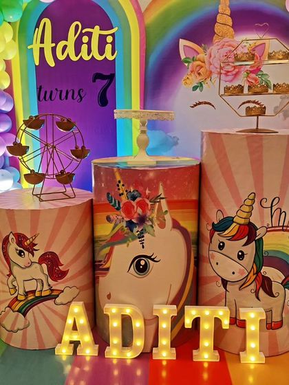 A close-up of unicorn-themed dessert plinths, featuring cute unicorn graphics and a mini ferris wheel.