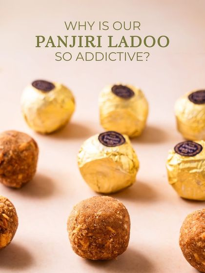 Why is my Panjiri Laddoo so addictive? This image of golden-wrapped laddoos tempts you to discover the rich, wholesome flavor for yourself.